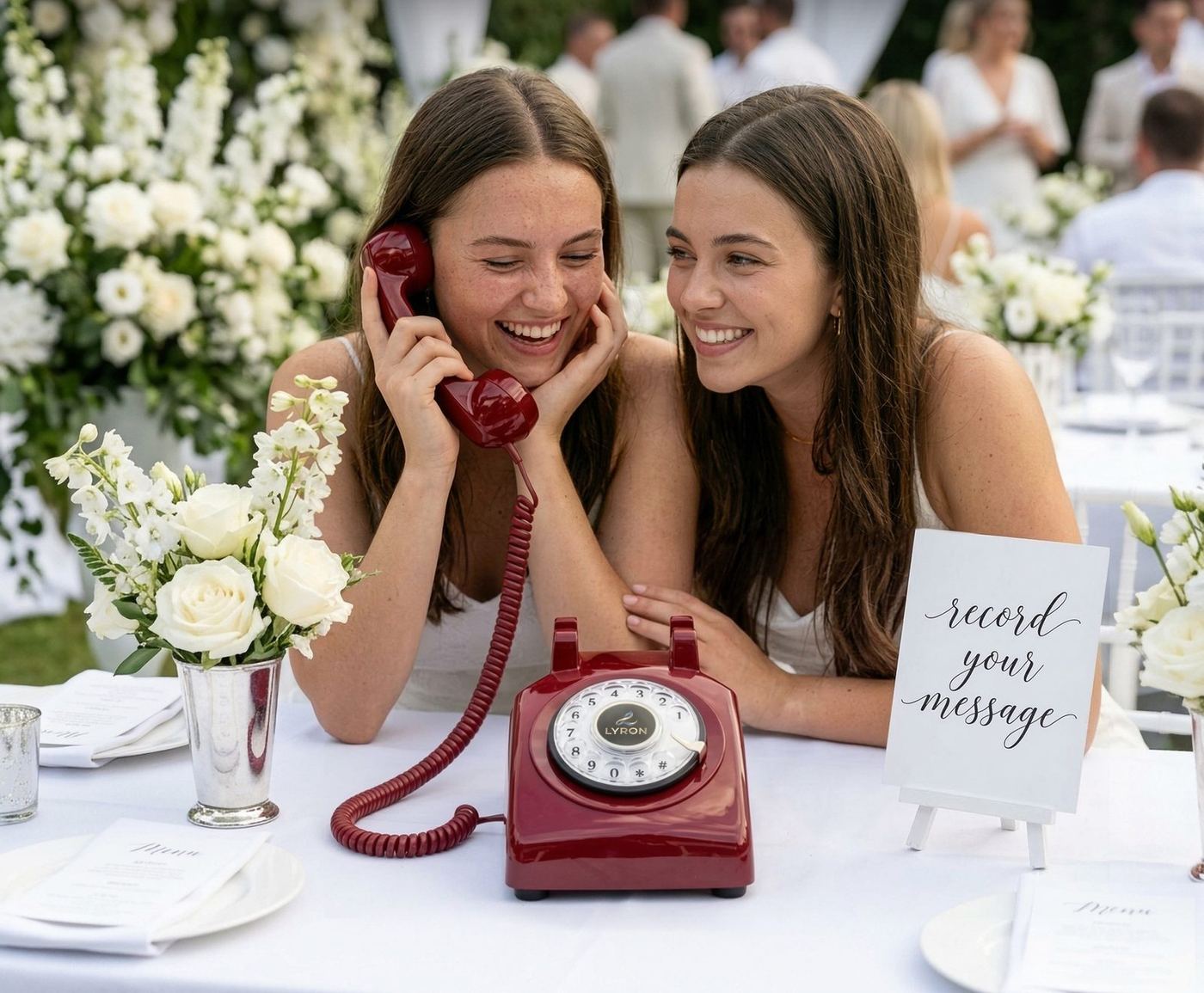 Two wedding guests laughing while leaving a message